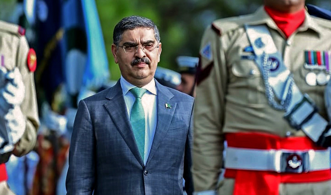 In this handout photograph taken and released by the Pakistan's Press Information Department (PID) on August 14, 2023, Pakistan's newly appointed caretaker Prime Minister, Anwaar-ul-Haq Kakar (L) is presented with guard of honor at the Prime Minister House in Islamabad. (PID/File)