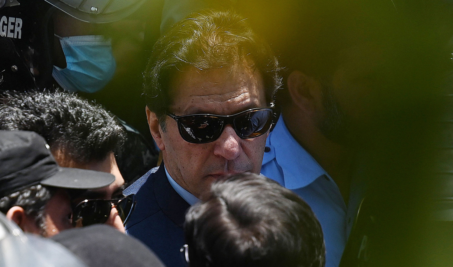 Police cammandos escort former Pakistan's Prime Minister Imran Khan as he arrives at the high court in Islamabad on May 12, 2023. (AFP/File)