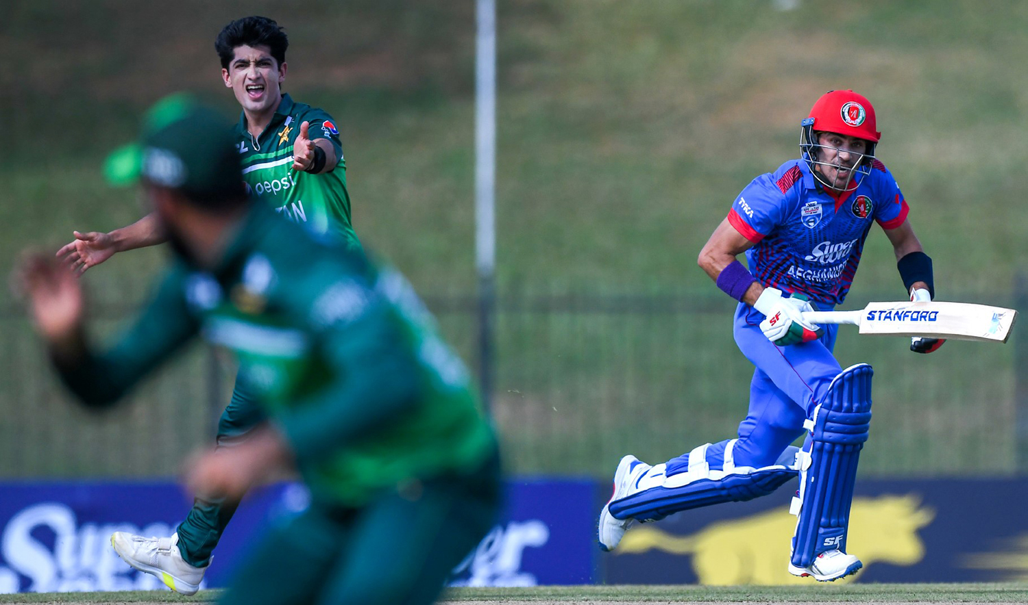 Afghanistan's Rahmanullah Gurbaz, right, runs between the wickets as Pakistan's Naseem Shah, left, watching during the second one-day international (ODI) cricket match between both teams at the Mahinda Rajapaksa International Cricket Stadium in Hambantota on August 24, 2023. (AFP)