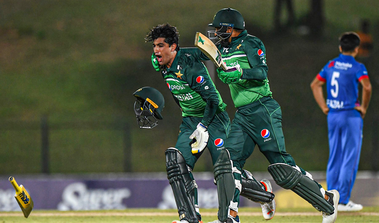 Pakistan's Naseem Shah, left, and Haris Rauf celebrate after Pakistan won by 1 wicket during the second one-day international (ODI) cricket match against Afghanistan at the Mahinda Rajapaksa International Cricket Stadium in Hambantota, on August 24, 2023. (AFP)