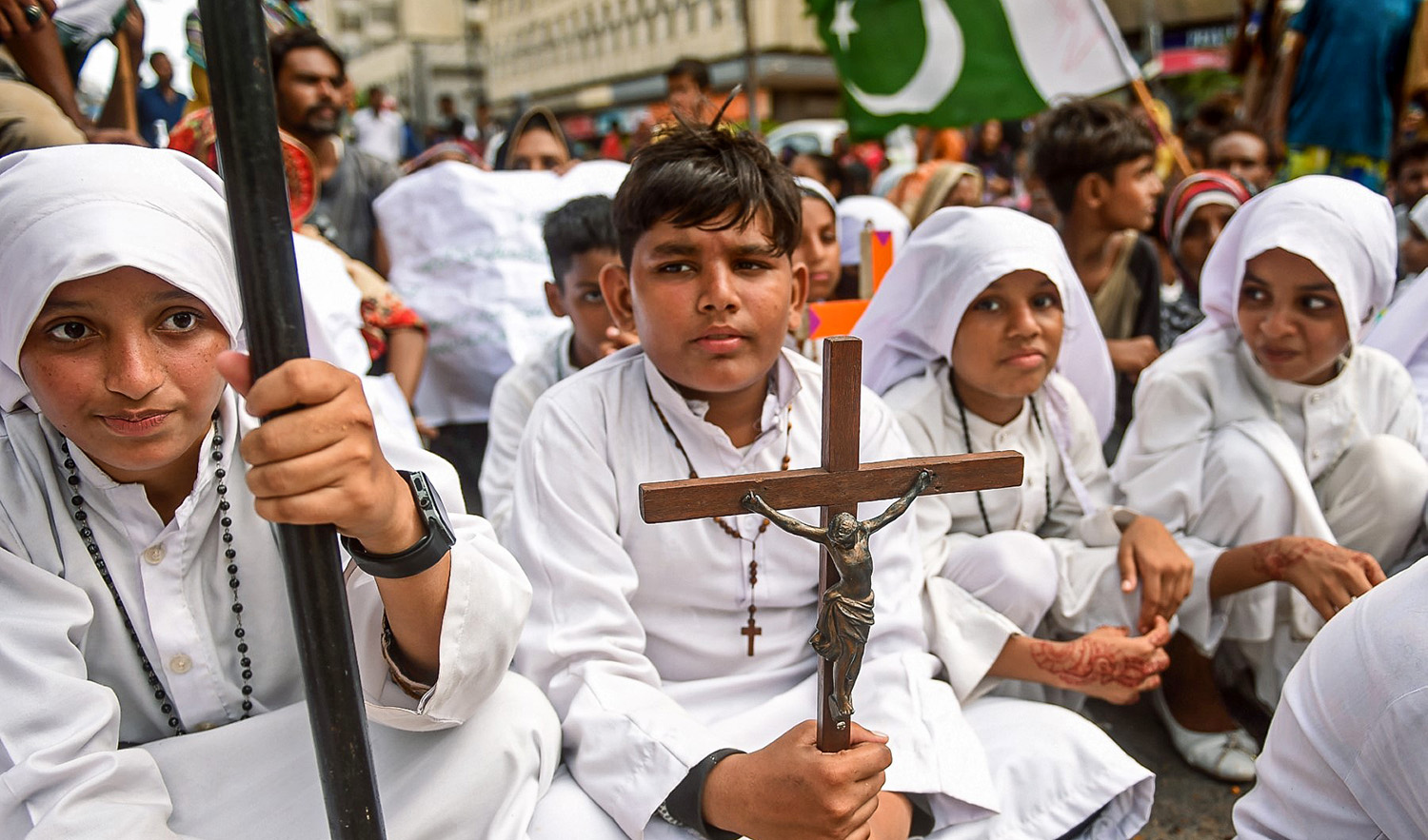A Christian boy holds the cross during a protest in Karachi, Pakistan on August 22, 2023. (AFP/File)