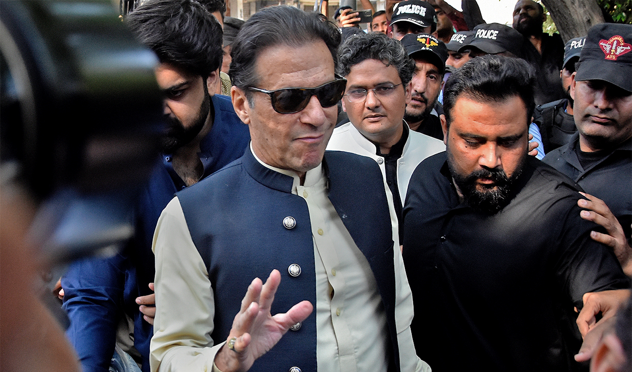 Former Pakistani Prime Minister Imran Khan, center, arrives to the Islamabad High Court surrounded by security, in Islamabad, Pakistan, on October 3, 2022. (AP/File)