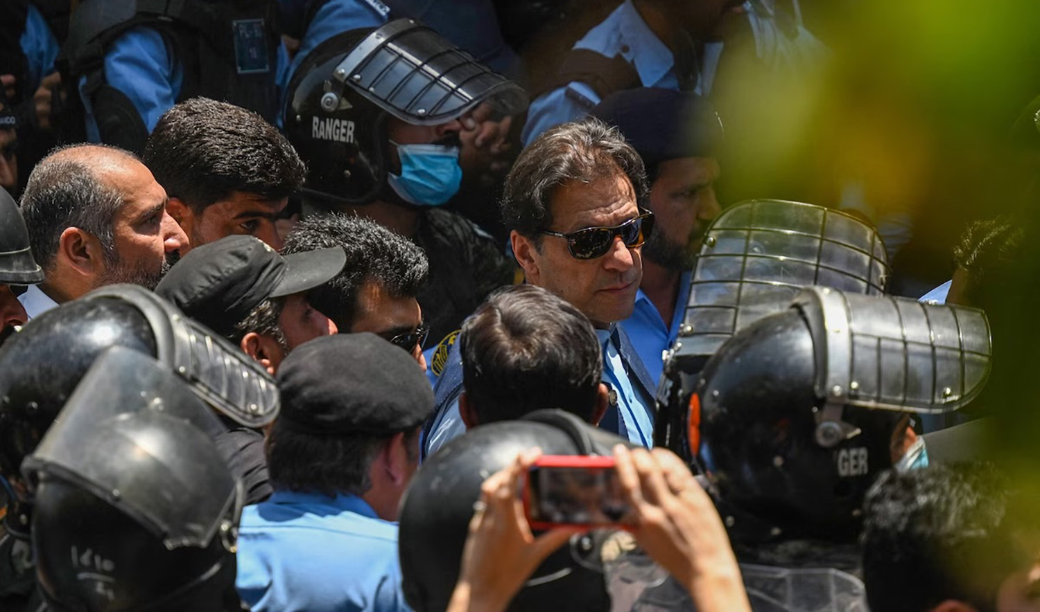 Police escort Imran Khan, Pakistan's former prime minister, as he arrives at the high court Friday in Islamabad on May 12, 2023. (AFP/File)