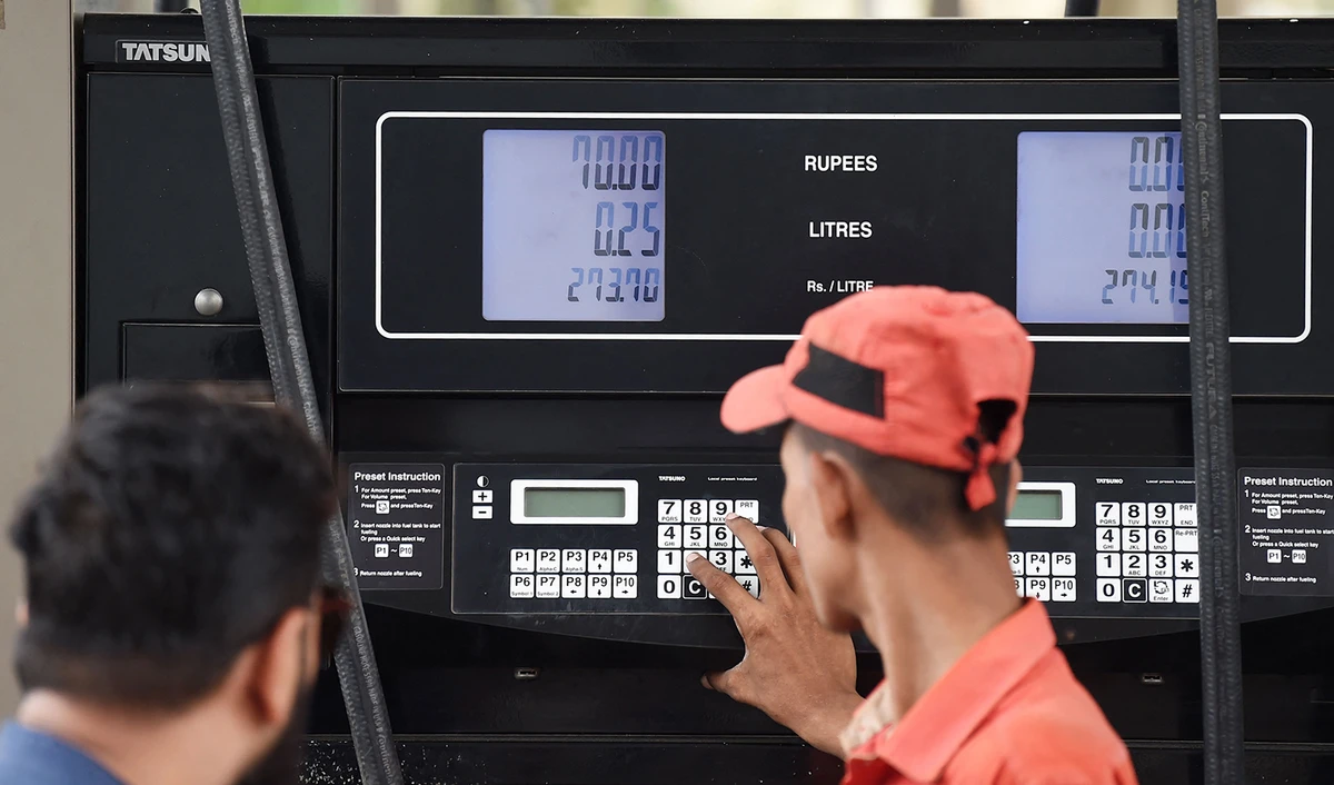 An employee prepares to fill petrol in a vehicle at a fuel station in Karachi, Pakistan on August 1, 2023. (AFP)
