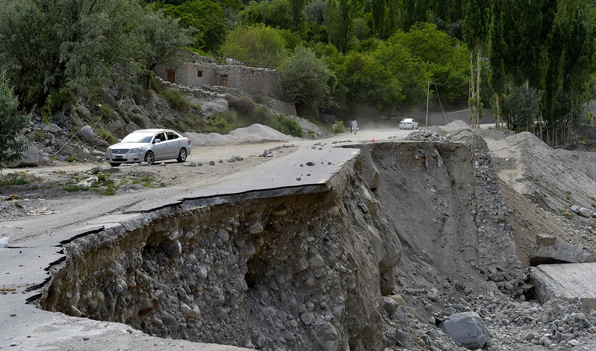 In this picture taken on June 9, 2022, a vehicle drives past a partially collapsed section of the Karakoram Highway in Pakistan's Gilgit-Baltistan region. (AFP/File)
