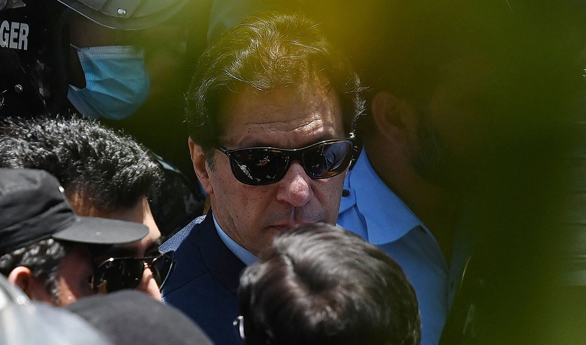 Police cammandos escort former Pakistan's Prime Minister Imran Khan as he arrives at the high court in Islamabad on May 12, 2023. (AFP/File)