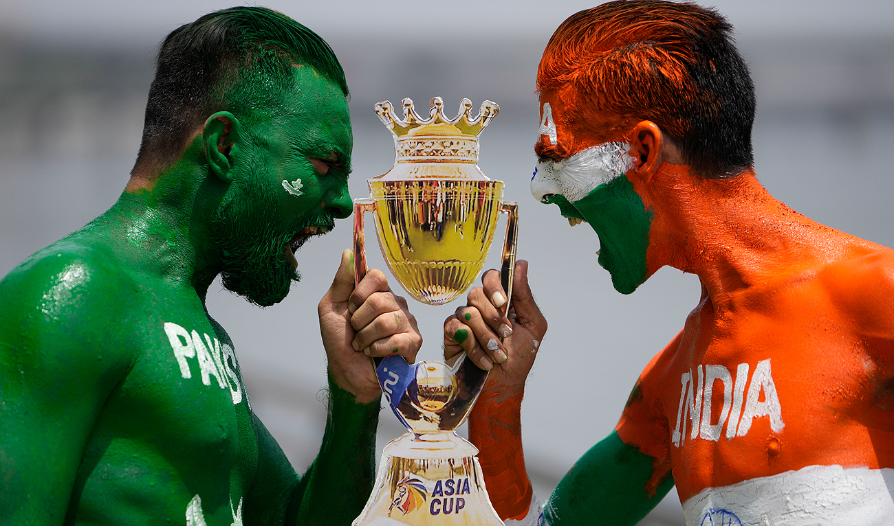 Indian cricket fans, their bodies painted in the colors of the national flags of India and Pakistan, pose for photographs in Ahmedabad, India, Friday, Sept. 1, 2023. India and Pakistan will play an Asia Cup cricket match in Sri Lanka on Saturday. (AP)