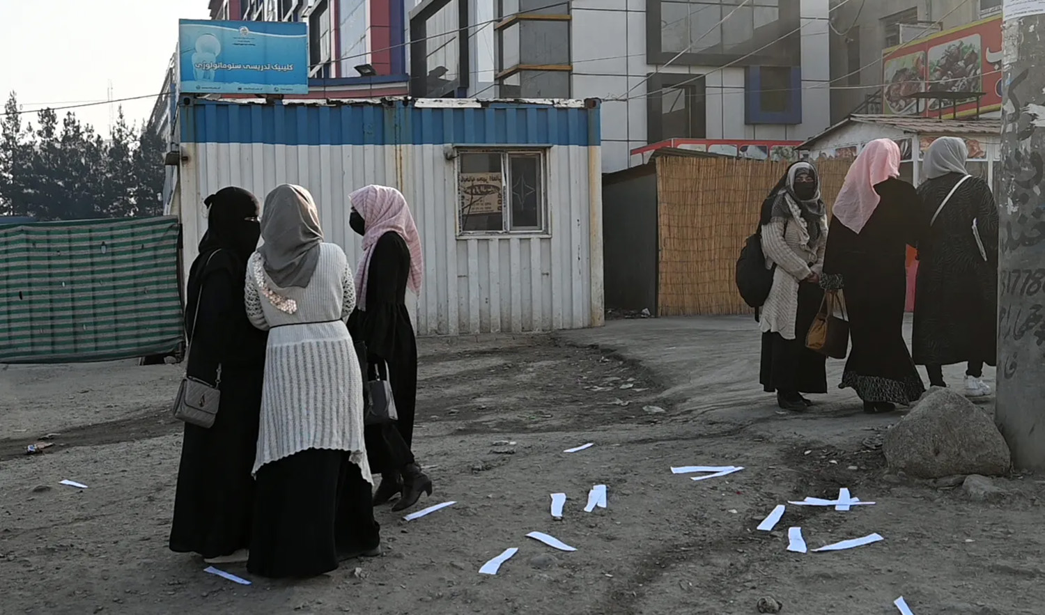 Afghan female university students walk on their on way back home past a private university in Kabul, Afghanistan, on December 21, 2022. (AFP/File)