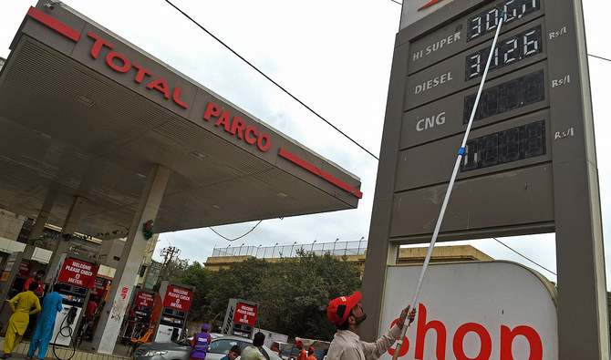 An employee updates the fuel prices at a fuel station in Karachi, Pakistan, on September 1, 2023. (AFP)