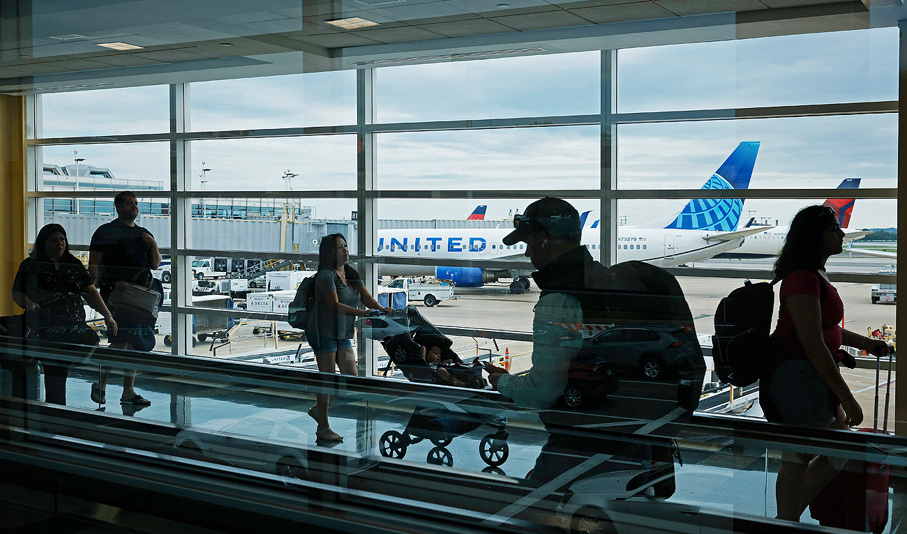 Passengers walk between terminals at Ronald Reagan Washington National Airport on August 08, 2023 in Arlington, Virginia. (AFP/File)