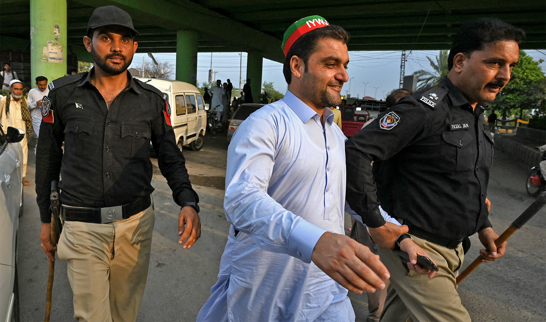 Police personnel arrest a member of Pakistan Tehreek-e-Insaf (PTI) party during a protest denouncing the arrest of Pakistan's former Prime Minister Imran Khan, during a protest in Peshawar, Pakistan on August 5, 2023. (Photo courtesy: AFP)