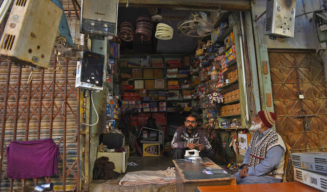 A shopkeeper sits inside his electronic repairing shop in Karachi, Pakistan, on January 10, 2021. (Photo courtesy: AFP/File)