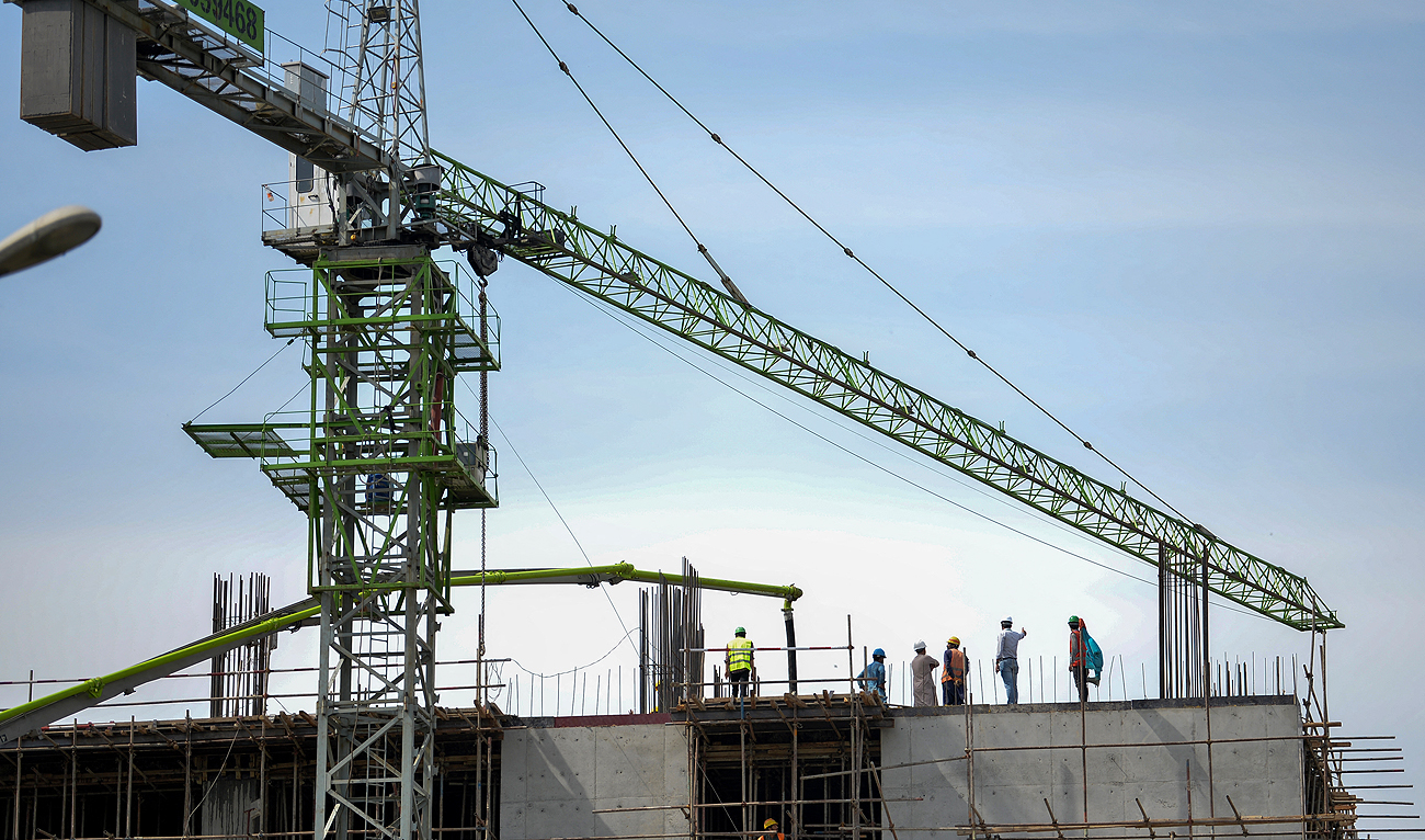 Labourers work at the construction site of a building in Islamabad on March 28, 2023. (AFP/File)