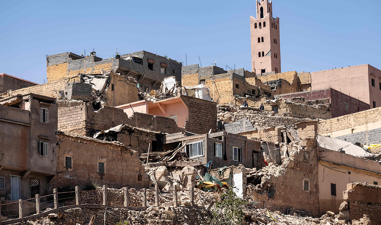 The minaret of a mosque stands behind damaged or destroyed houses following an earthquake in Moulay Brahim, Al-Haouz province, on September 9, 2023. (AFP)