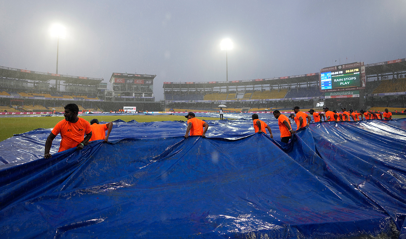 Ground staff pull covers as it rains during the Asia Cup cricket match between India and Pakistan in Colombo, Sri Lanka, Sunday, Sept.10, 2023. (AP)