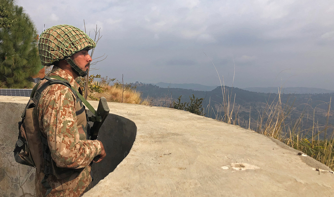 A Pakistan's army soldier stands guard on the Line of Control (LoC) at Abdullah Pur village in Bhimber district of Pakistani-controlled Kashmir on February 5, 2021. (AFP/File)