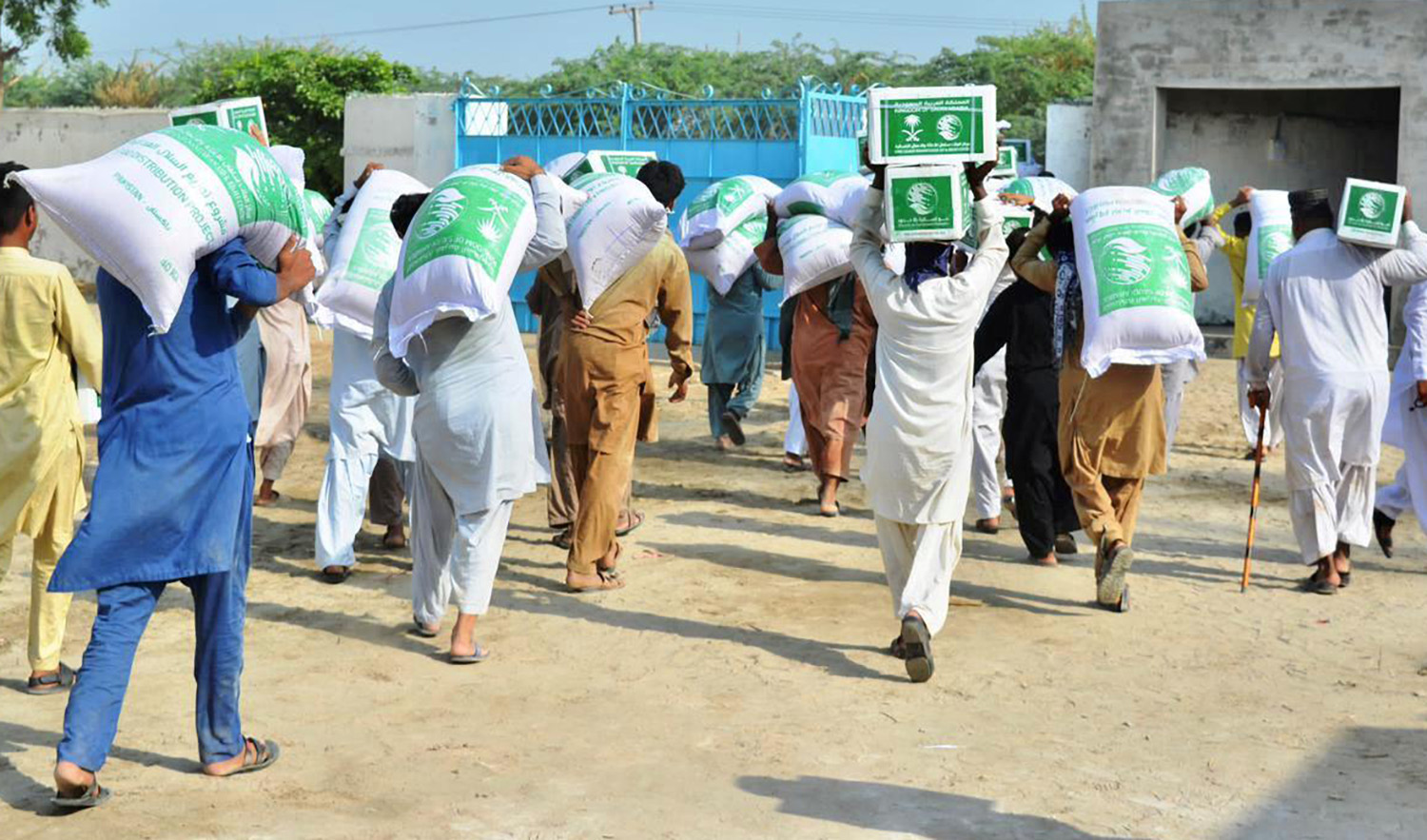 In an undated photo, Pakistani flood affectees can be seen taking King Salman Humanitarian Aid and Relief Centre (KSrelief) food packets and relief items. (SPA)