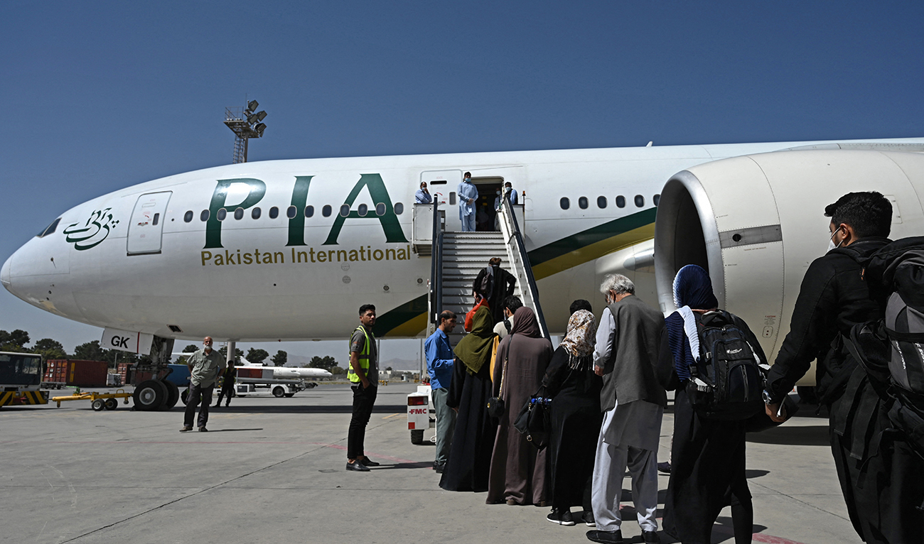 Passengers board a Pakistan International Airlines (PIA) flight, the first commercial international flight since the Taliban retook power last month, at the airport in Kabul on September 13, 2021. (AFP/File)