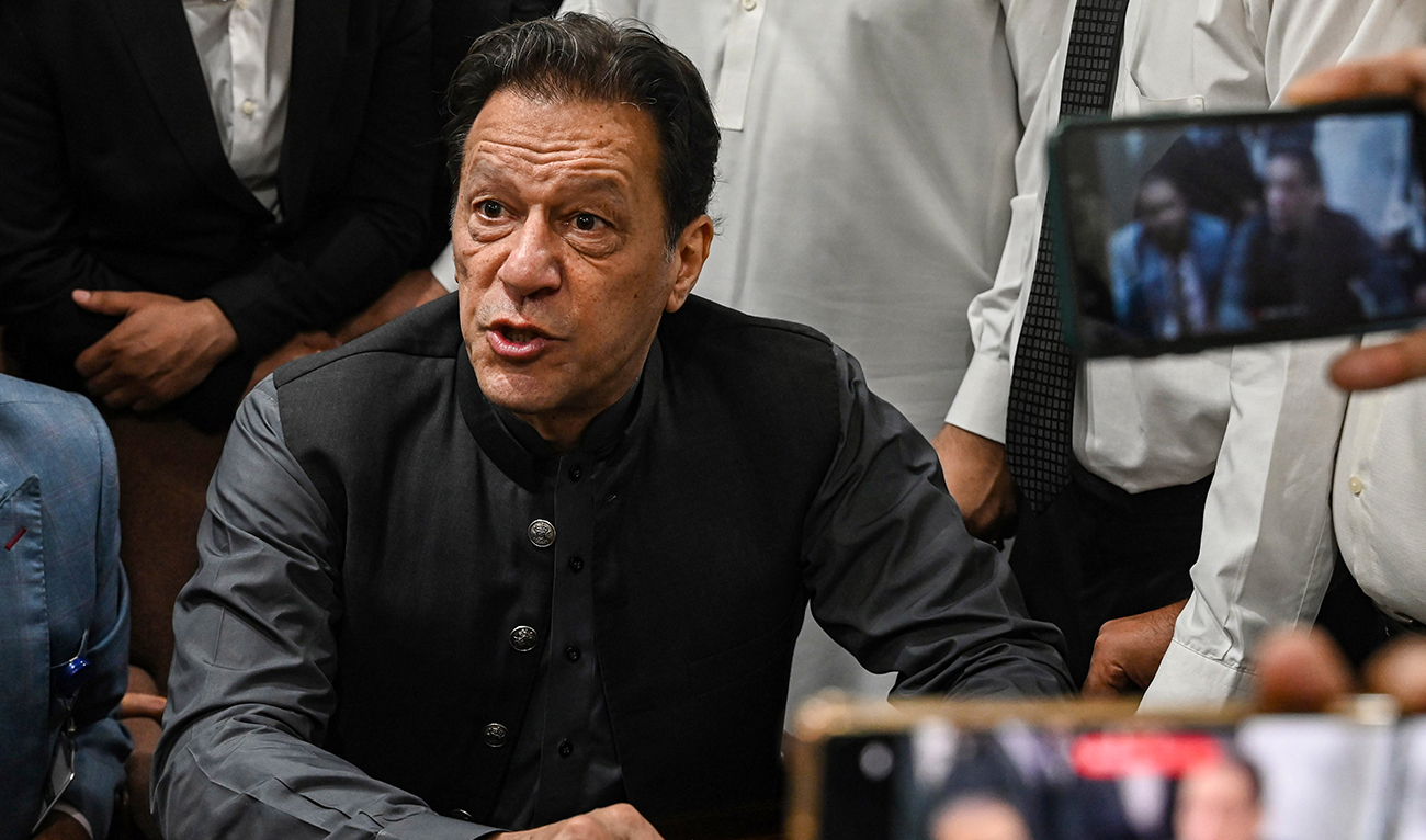 Pakistan's former prime minister, Imran Khan gestures after arriving at a registrar office in Lahore High court to sign surety bonds for bail in various cases, in Lahore on July 3, 2023. (AFP/File)