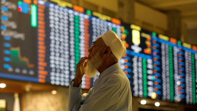 A stock broker reacts while monitoring the market on the electronic board displaying share prices during trading session at the Pakistan Stock Exchange, in Karachi, Pakistan July 3, 2023. (REUTERS/File)