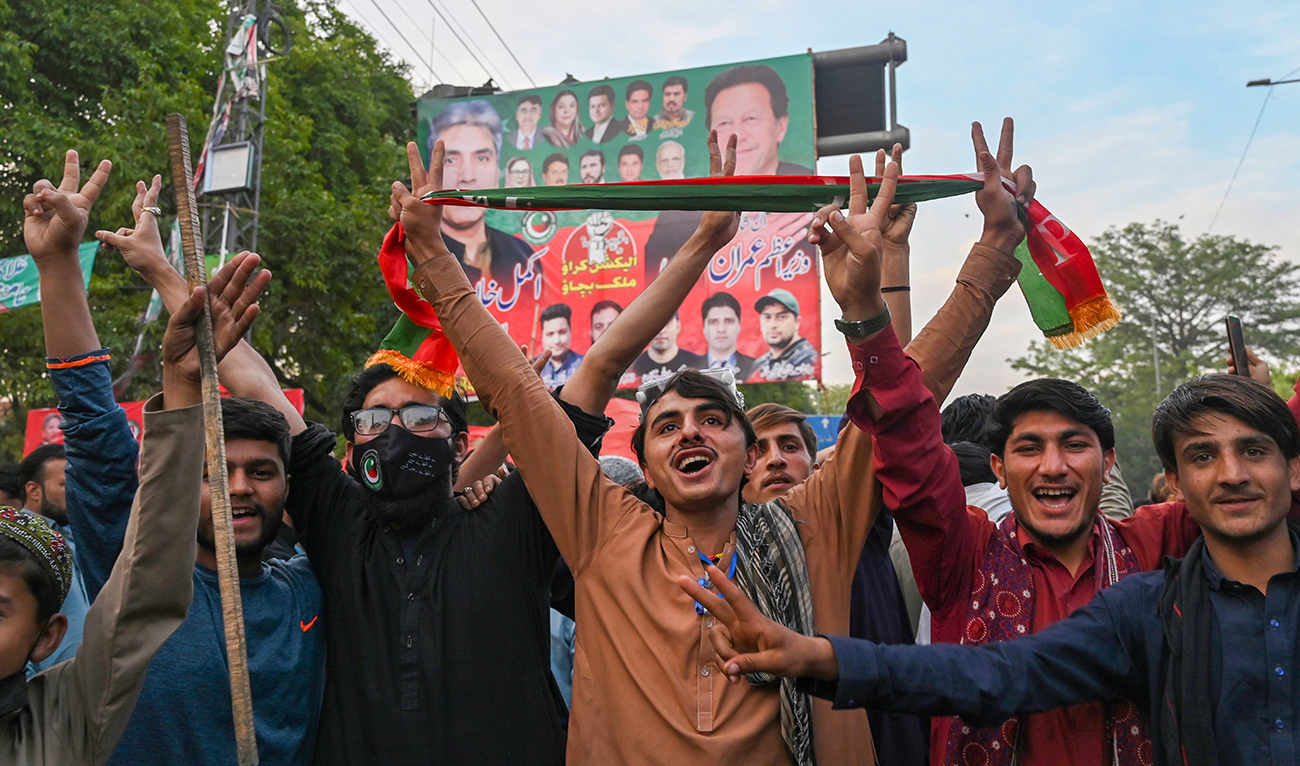 Pakistan Tehreek-e-Insaf (PTI) party activists and supporters of Pakistan's former Prime Minister Imran Khan celebrate after Supreme Court declared Khan's arrest "invalid", in Lahore on May 11, 2023. (AFP/File)