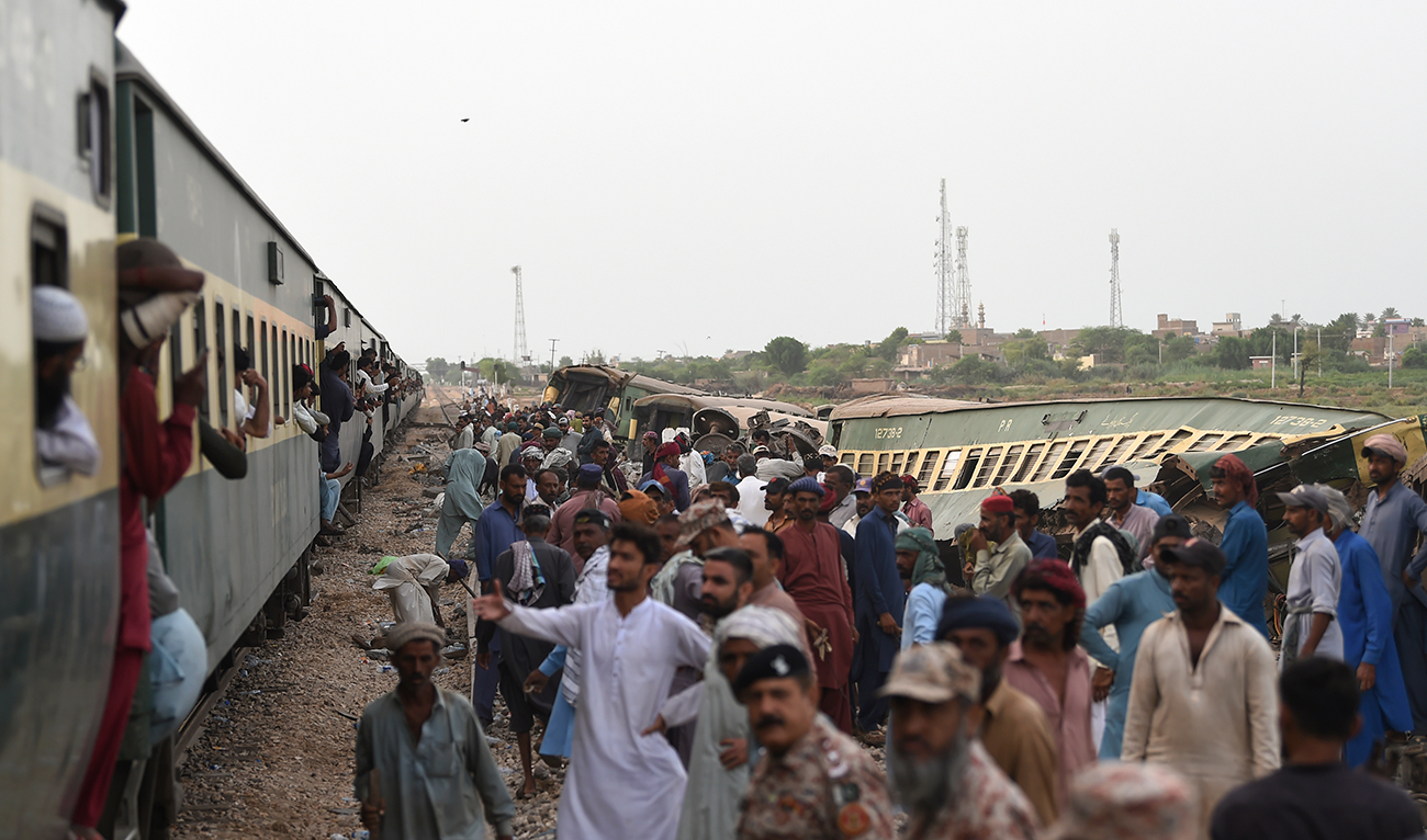 Railway workers repaire the tracks next to damaged carriages a day after the derailment of a passenger train in NawabShah on August 7, 2023. (AFP/File)