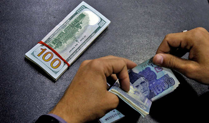 A currency trader counts Pakistani Rupee notes as he prepares an exchange of US dollars in Islamabad, Pakistan on December 11, 2017. (REUTERS/File)
