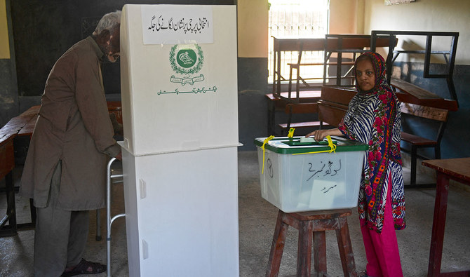 Voters cast their ballot at a polling station during the by-election for national assembly seats, in Karachi on October 16, 2022. (AFP/File)
