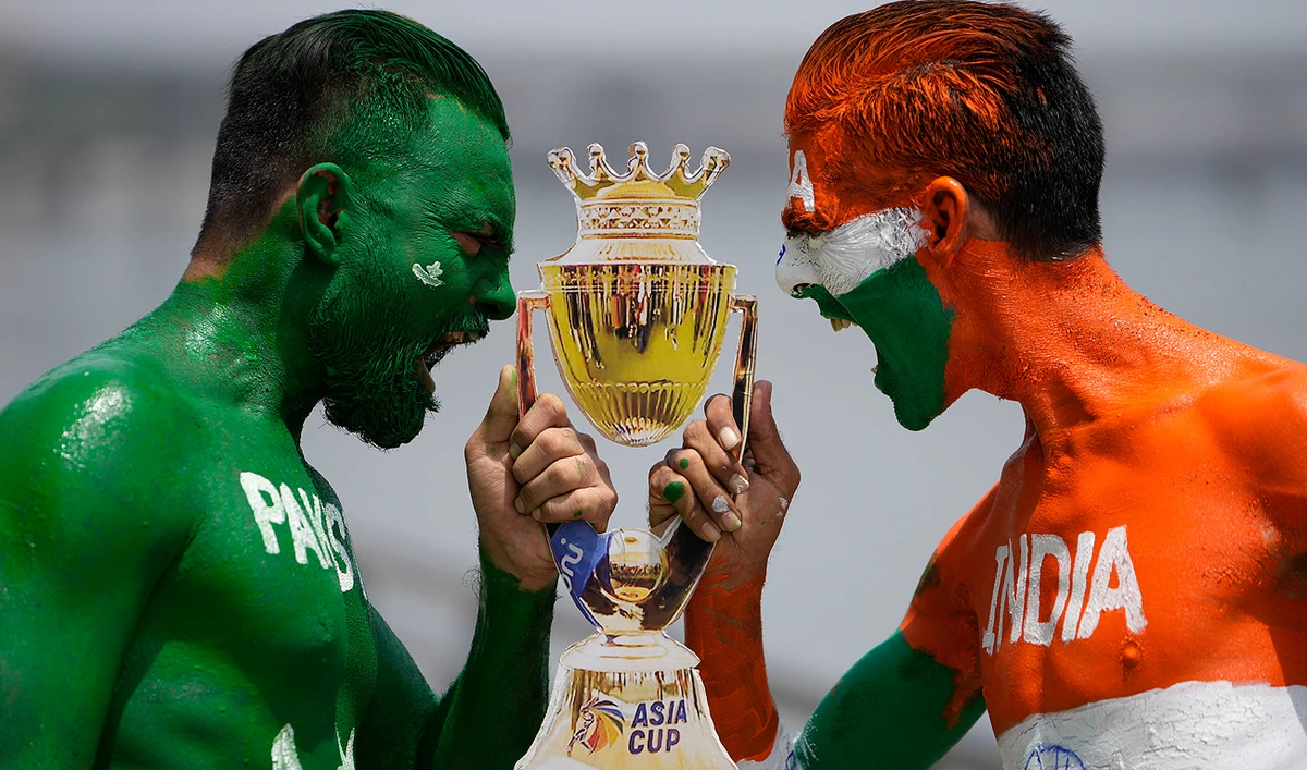 Indian cricket fans, their bodies painted in the colors of the national flags of India and Pakistan, pose for photographs in Ahmedabad, India, Friday, Sept. 1, 2023. India and Pakistan will play an Asia Cup cricket match in Sri Lanka on Saturday. (AP)