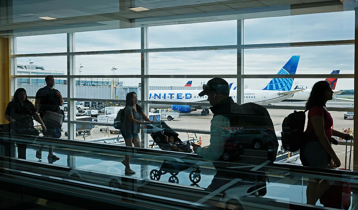 Passengers walk between terminals at Ronald Reagan Washington National Airport on August 08, 2023 in Arlington, Virginia. (AFP/File)