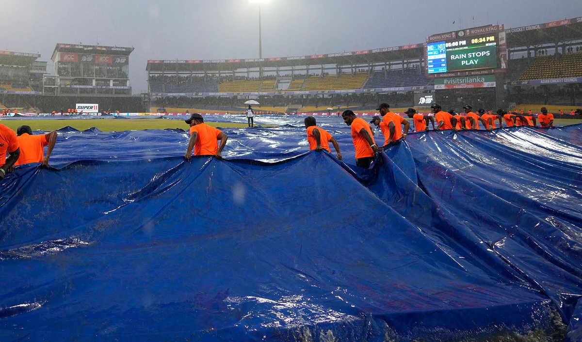 Ground staff pull covers as it rains during the Asia Cup cricket match between India and Pakistan in Colombo, Sri Lanka, on September 10, 2023. (AP)