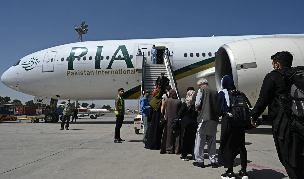 Passengers board a Pakistan International Airlines (PIA) flight at the airport in Kabul, Afghanistan, on September 13, 2021. (AFP/File)