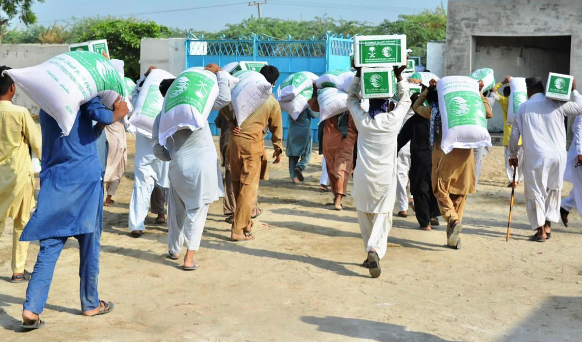 In an undated photo, Pakistani flood affectees can be seen taking King Salman Humanitarian Aid and Relief Centre (KSrelief) food packets and relief items. (SPA)