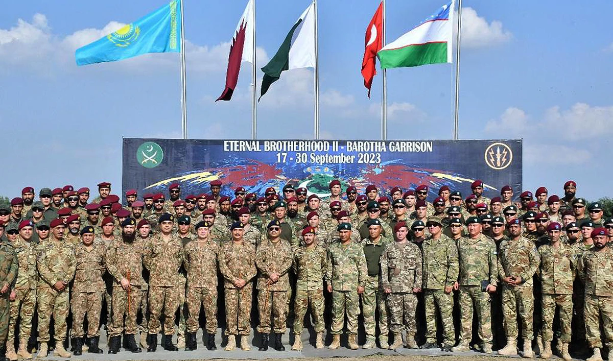 In this handout photograph, taken on September 19, 2023 and released by Pakistan's Inter Service Public Relation (ISPR), Pakistan Army Chief General Asim Munir gestures for a group photo with special forces contingents from Pakistan, Kazakhstan, Qatar, Turkiye and Uzbekistan during a two-week multinational military exercise at Barotha Garrision in Attock city. (Photo courtesy: ISPR)
