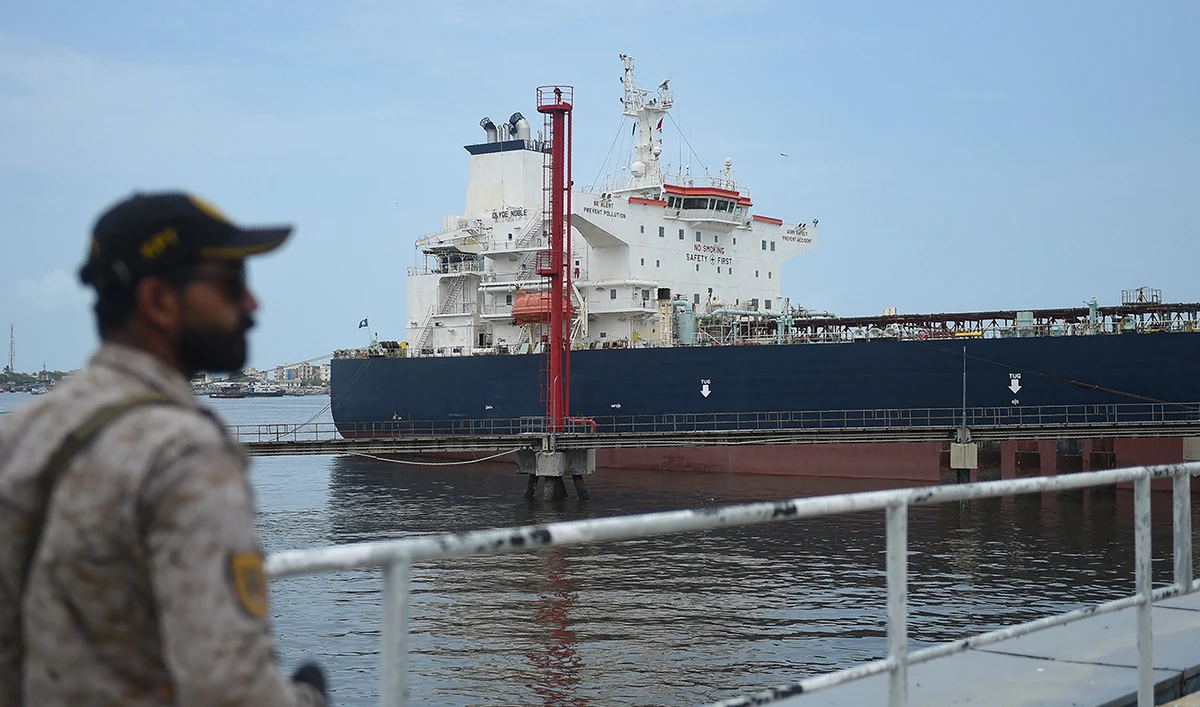 A security personnel stands guard near a Russian cargo ship carrying crude oil docked at the Karachi port in Karachi on June 28, 2023. (AFP/File)