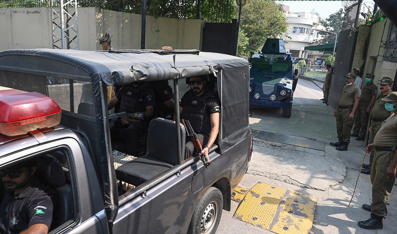 A police car escorts an armed vehicle leaving the court premises in Lahore, Pakistan, on October 13, 2020. (AFP/File)