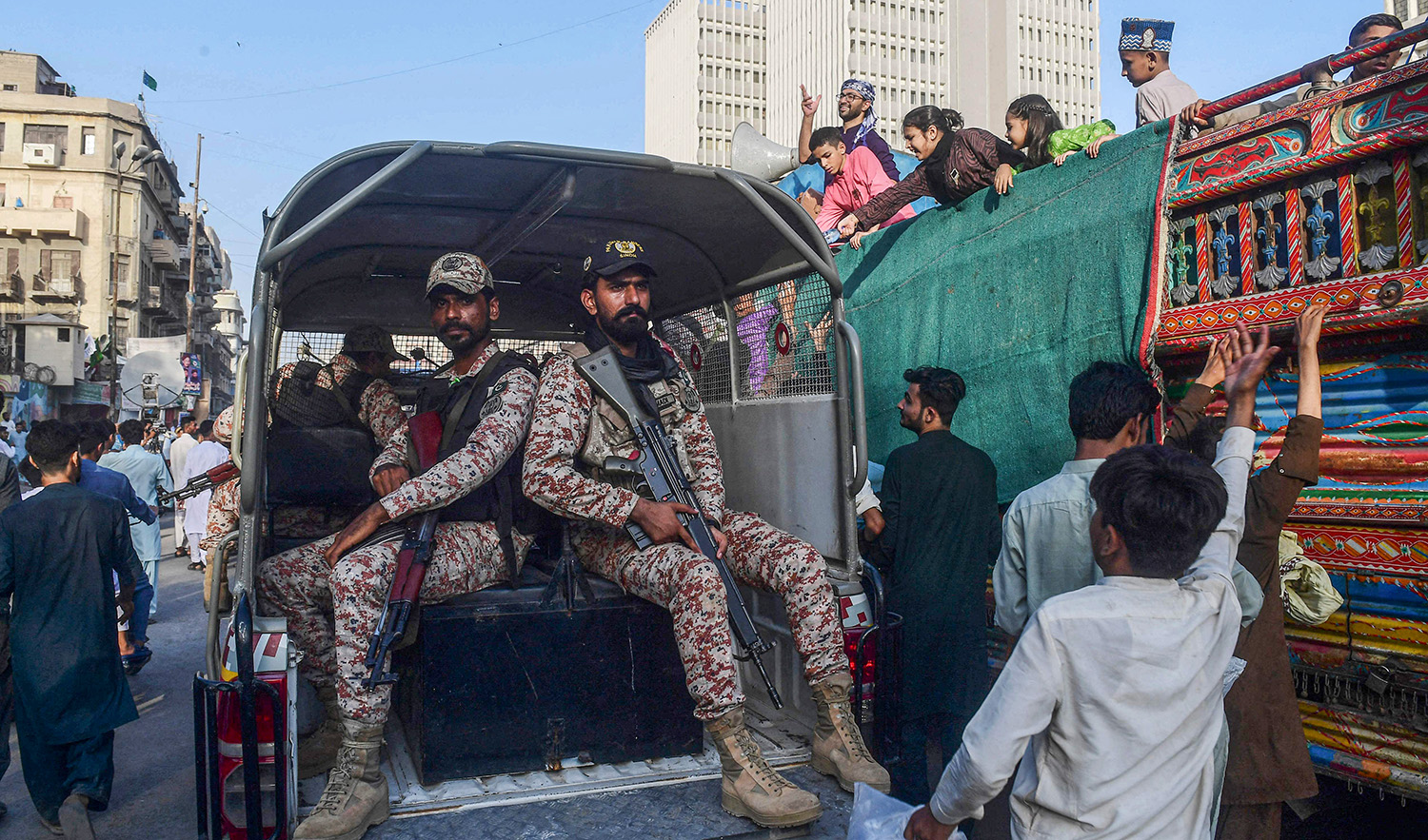 Paramilitary soldiers patrol as Muslim devotees take part in a rally to celebrate the birthday anniversary of Prophet Muhammad (PBUH), in Karachi, Pakistan on September 29, 2023. (AFP)
