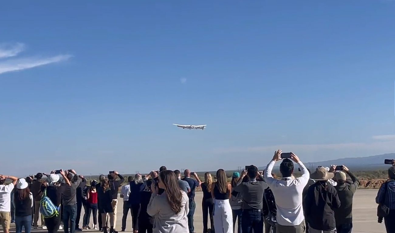 In this screengrab, taken from a video released by Virigin Galactic, media personnel take pictures of Virgin Galactic's fifth flight while taking off into space, carrying four people on board, including the Pakistani woman, at the Spaceport in New Mexico on October 6, 2023. (Photo courtesy: Virgin Galactic)