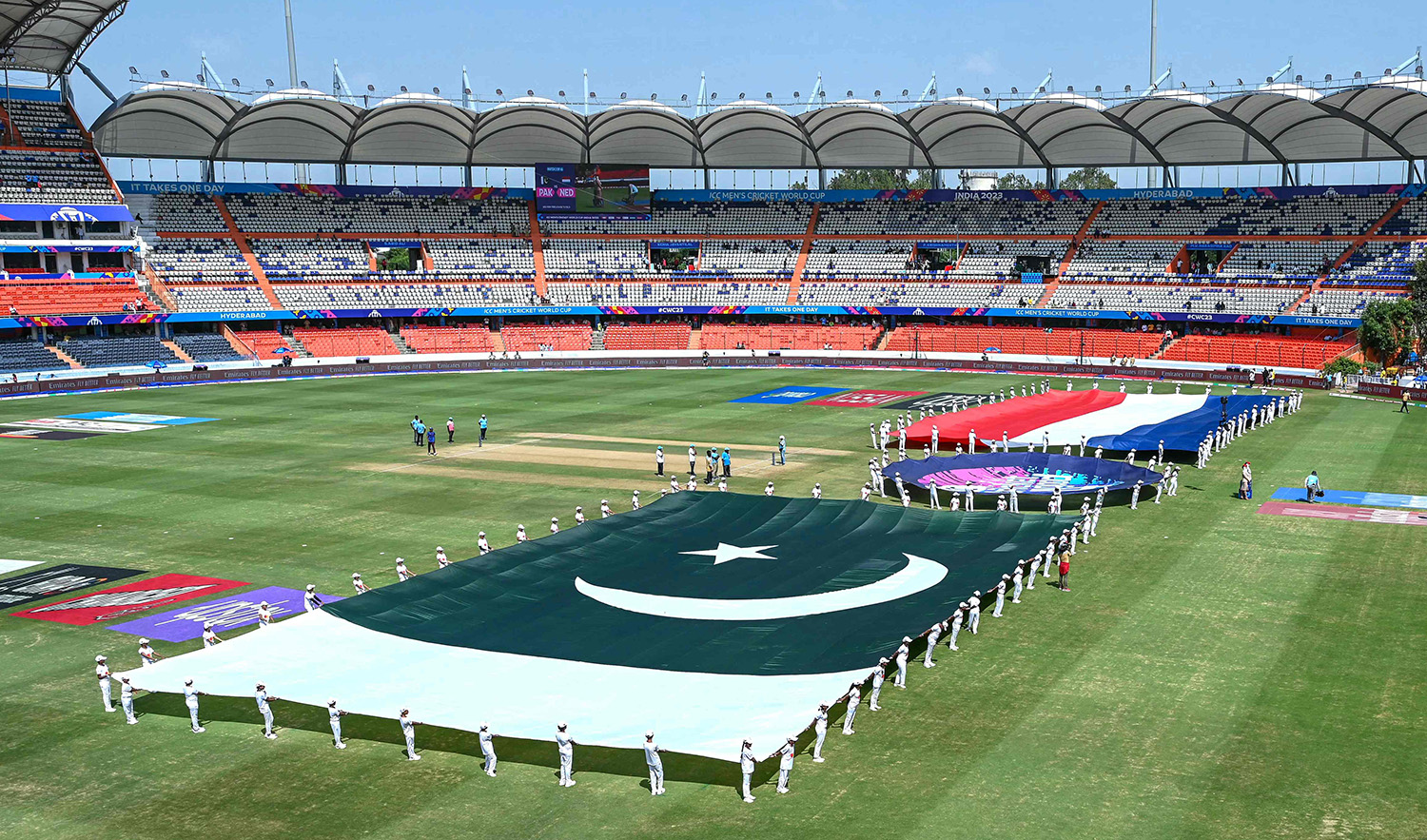 Volunteers hold Netherlands' and Pakistan's flags for national anthems before the start of the 2023 ICC Men's Cricket World Cup one-day international (ODI) match at the Rajiv Gandhi International Stadium in Hyderabad, India on October 6, 2023. (AFP)