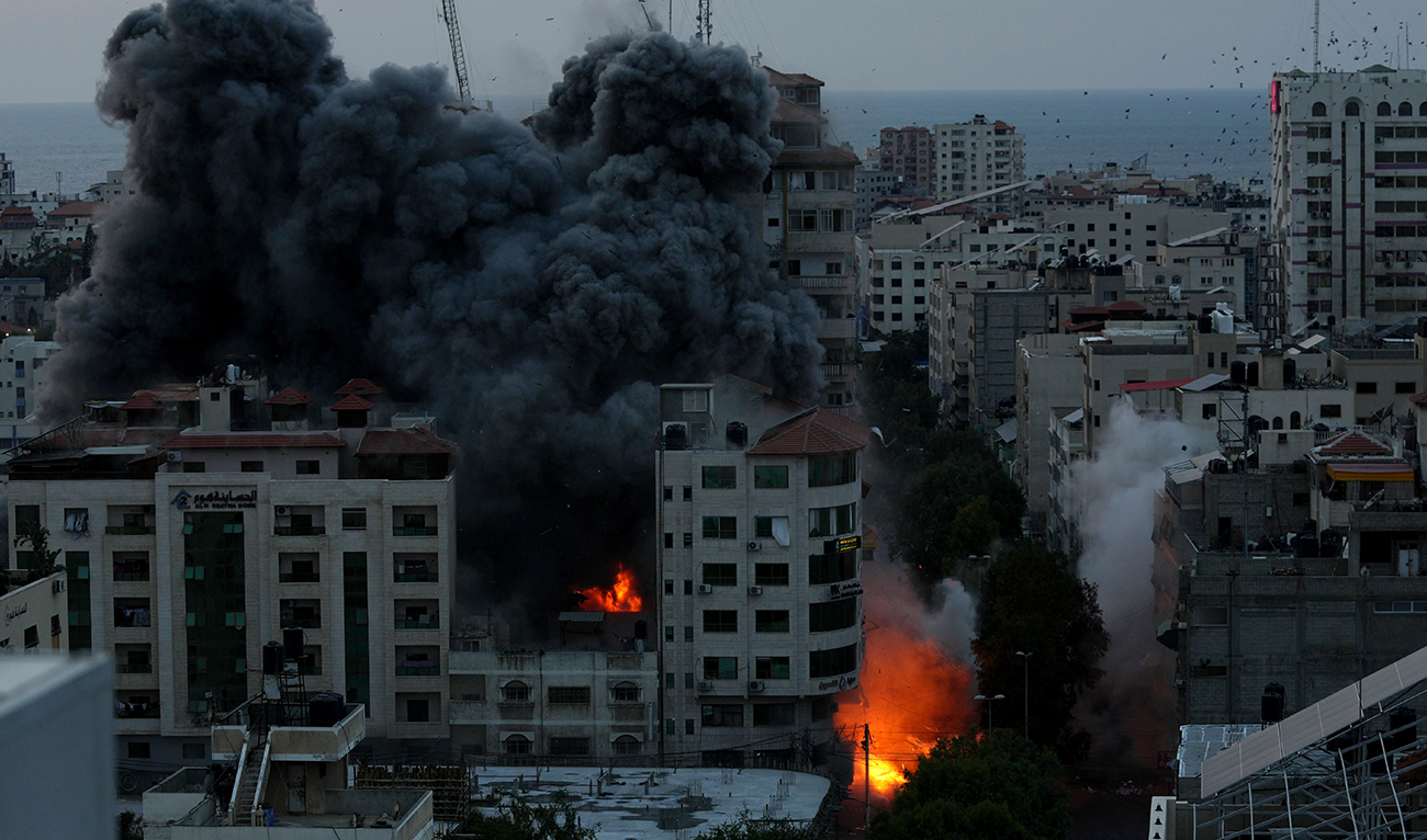 Fire and smoke rise from an explosion on a Palestine apartment tower following an Israeli air strike in Gaza City, on October 7, 2023. (AP)