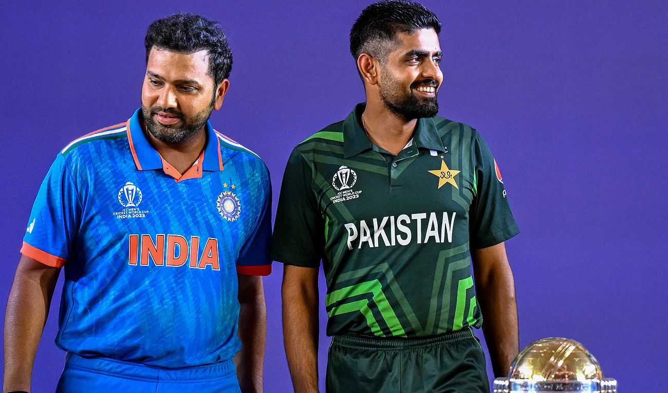 India’s captain Rohit Sharma (L) and his Pakistani counterpart Babar Azam stand beside the tournament trophy as they attend the Captains’ Day event, an interaction session between the captains of all participating teams and the media at the Narendra Modi Stadium in Ahmedabad on October 4, 2023, on the eve of the the 2023 ICC men's cricket World Cup one-day international (ODI) match between England and New Zealand. (AFP)