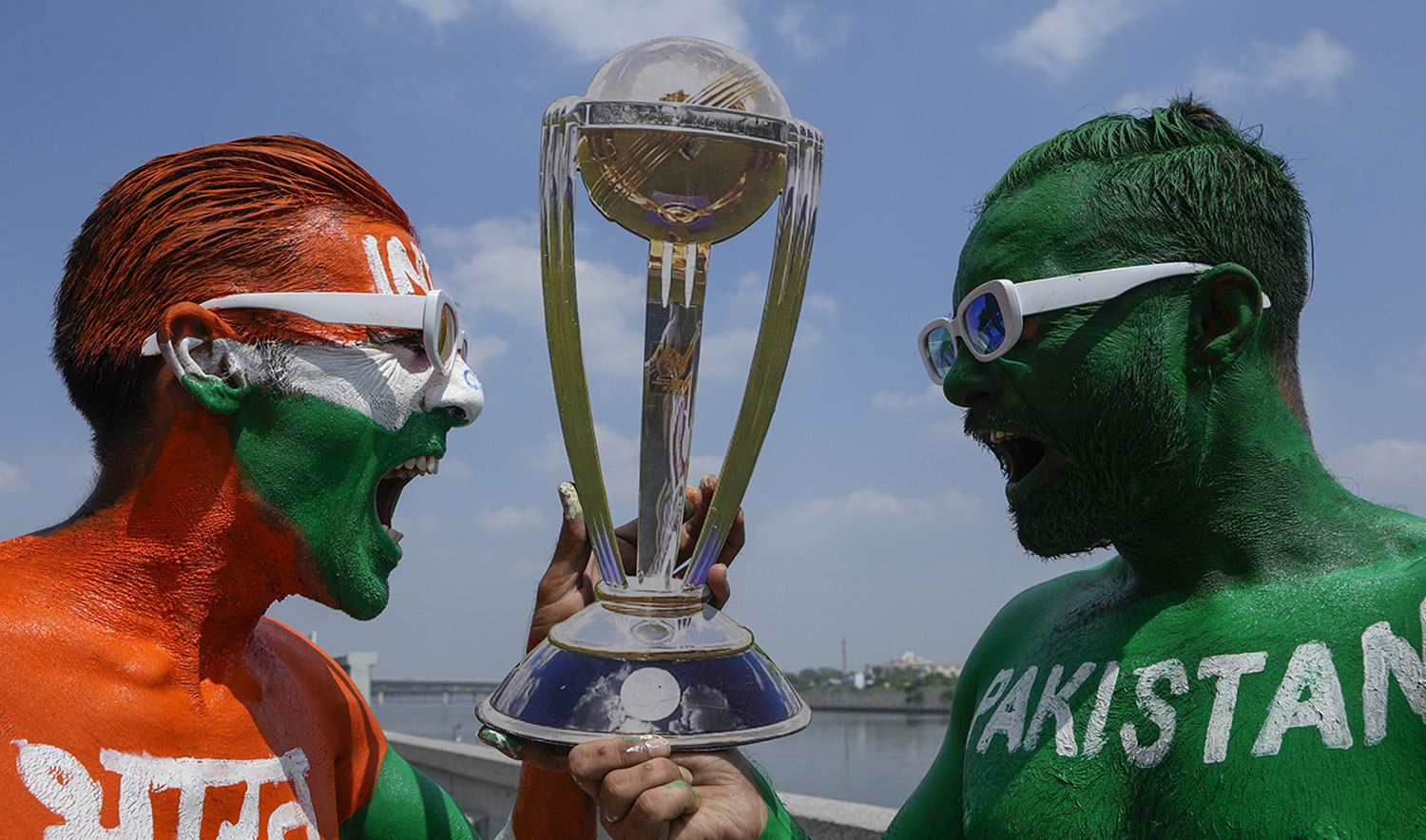 Cricket fans, their bodies painted in the colors of the national flags of India and Pakistan, pose for photographs in Ahmedabad, India, on October 11, 2023. (AP)