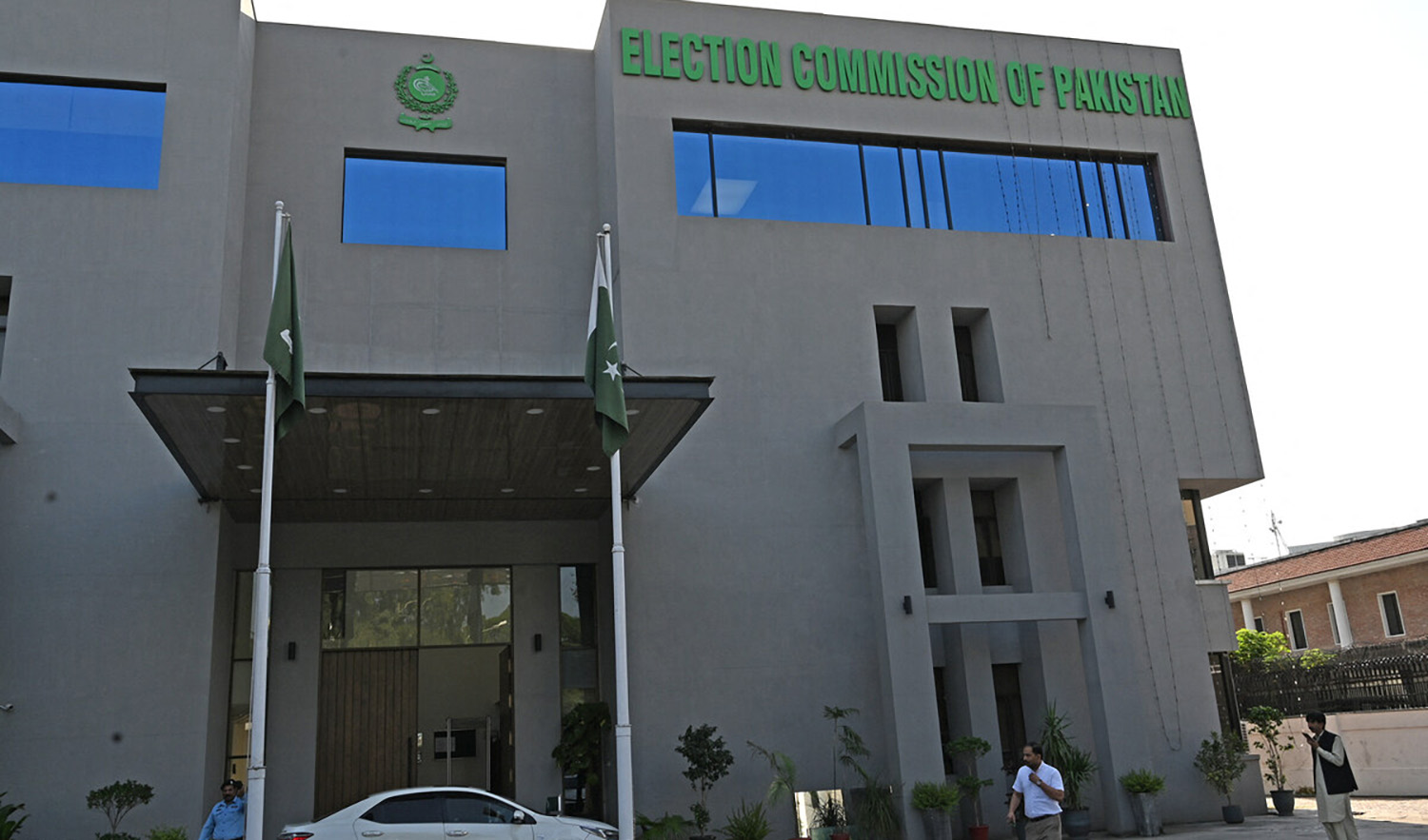 A security personnel, left, stands guard at the headquarters of Election Commission of Pakistan in Islamabad on September 21, 2023. (AFP/File)