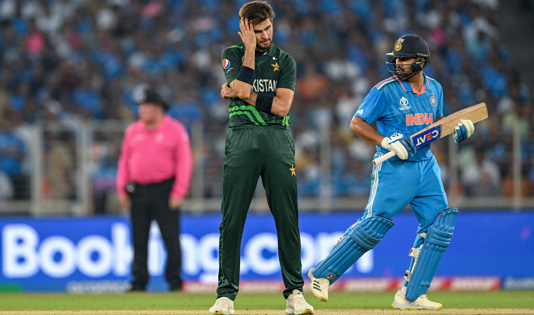 Pakistan's Shaheen Shah Afridi (L) gestures as India's captain Rohit Sharma runs between the wickets during the 2023 ICC Men's Cricket World Cup one-day international (ODI) match between India and Pakistan at the Narendra Modi Stadium in Ahmedabad on October 14, 2023. (REUTERS)