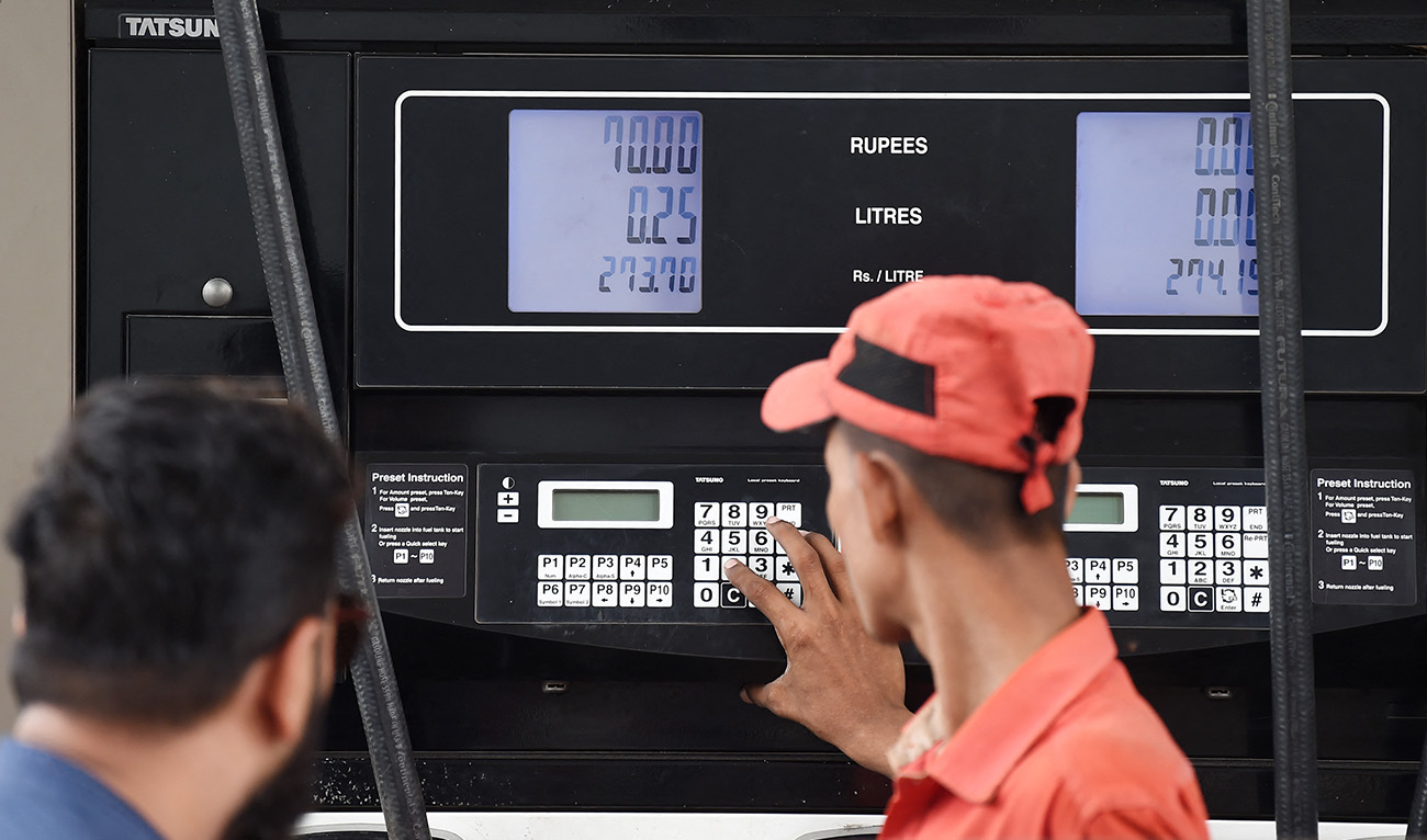 An employee prepares to fill petrol in a vehicle at a fuel station in Karachi on August 1, 2023. (AFP/File)