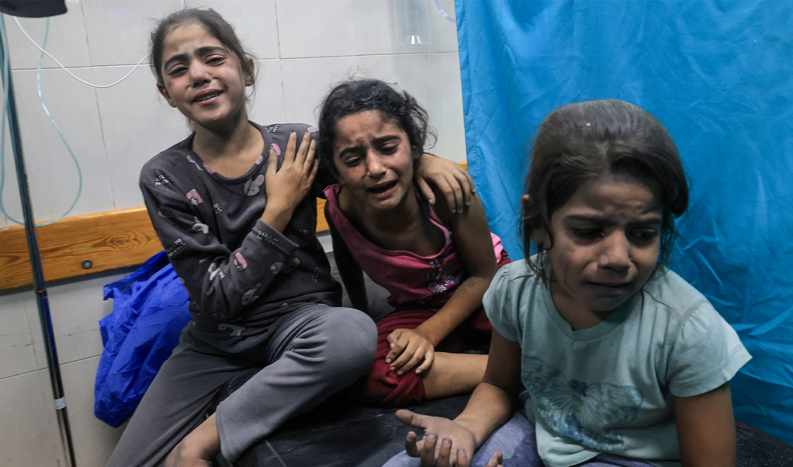Palestinian children injured in an Israeli air strike await treatment at the Nasser hospital in Khan Yunis in the southern of Gaza Strip, on October 17, 2023. (AFP)