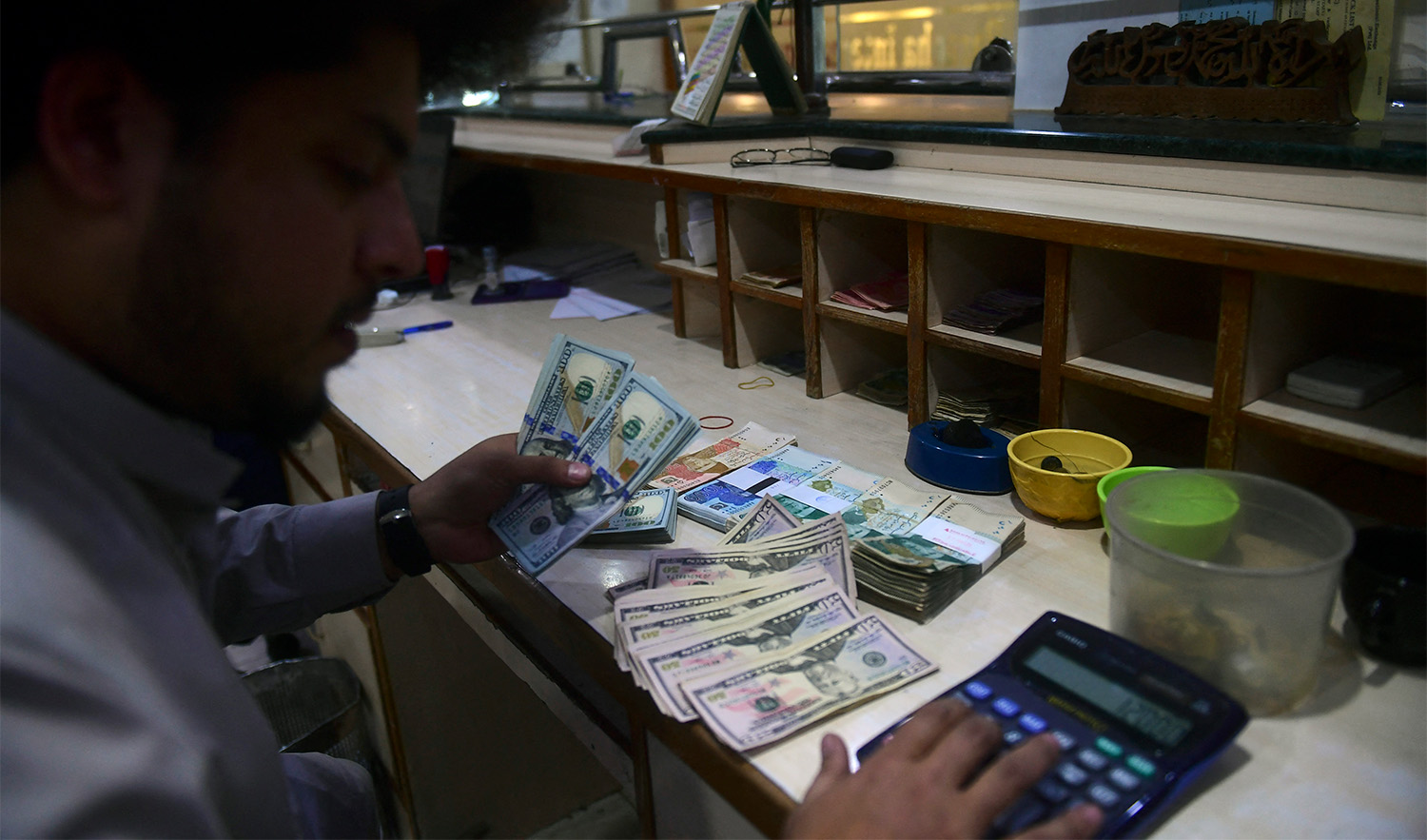 A dealer holds US dollars at a money exchange market in Karachi, Pakistan on January 26, 2023. (AFP/File)