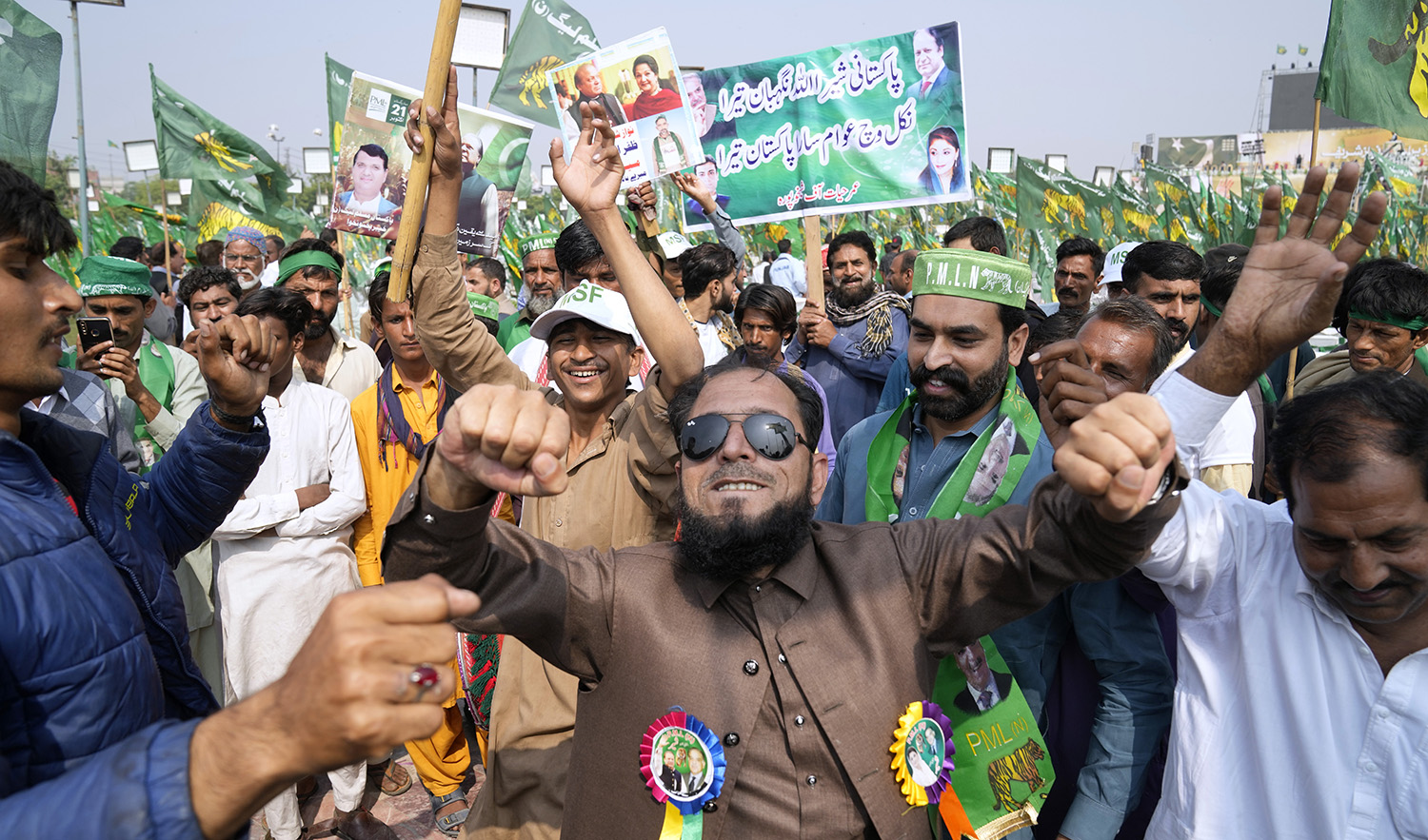 Supporters of Pakistan's former Prime Minister Nawaz Sharif dance on a traditional drum beat as they arrive to attend a welcoming rally for their leader, in Lahore, Pakistan, on October 21, 2023. (AP)