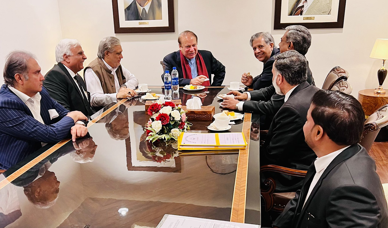 Former Pakistan Prime Minister Nawaz Sharif (center) consults with his party members and legal team at Islamabad International Airport on October 21, 2023. (Photo courtesy: @MIshaqDar50/X)