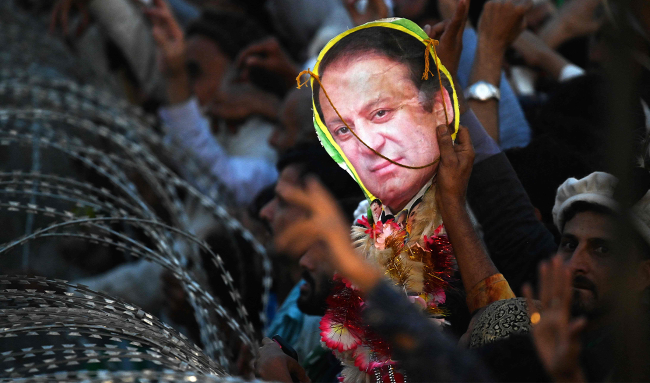 A supporter of Pakistan's former Prime Minister Nawaz Sharif holds a poster with his picture during an event held to welcome him in Lahore on October 21, 2023. (AFP)